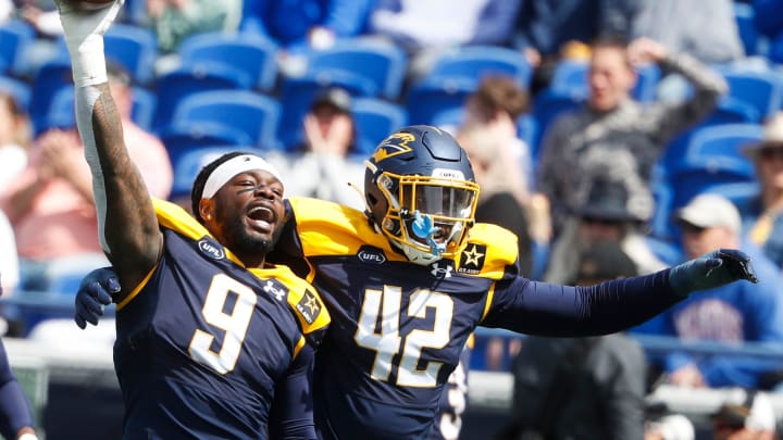 Showboat’s Maximillian Roberts (9) holds up the ball in celebration with Jordan Ferguson (42) after making a stop during the UFL game between the San Antonio Brahmas and Memphis Showboats in Simmons Bank Liberty Stadium in Memphis, Tenn., on Saturday, April 6, 2024.