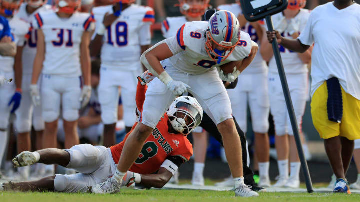 Bolles' Corbyn Fordham (9) rushes for yards against Mandarin's Izzy Ratliff (8) during the second quarter of a high school football matchup Thursday, May 23, 2024 at Mandarin High School in Jacksonville, Fla. Mandarin defeated Bolles 35-14.