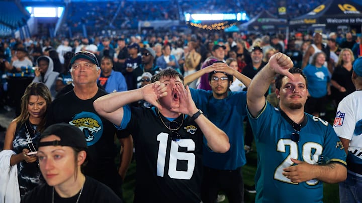 Coleman Marley, center, boos expressing his opinion of NFL Commissioner Roger Goodell kicks off the NFL Draft as Adam Watson gives a thumbs down, right, and Chandler Foster, back, looks on during the Duuuval Draft Party Thursday, April 25, 2024 at EverBank Stadium in Jacksonville, Fla. Thousands came out to watch the Jacksonville Jaguars choose in the 2024 NFL Draft.