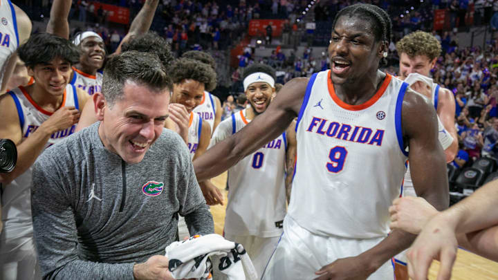 Florida head coach Todd Golden celebrates his 100th win and beating Mississippi State 108-77 with Florida center Rueben Chinyelu (9) and the rest of the team after an NCAA mens basketball game at Steven C. O'Connell Center Exactek arena in Gainesville, FL on Tuesday, March 3, 2026. [Alan Youngblood/Gainesville Sun]