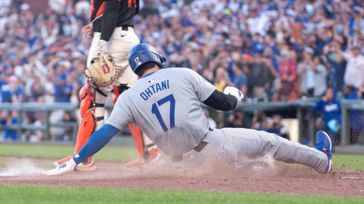 Jun 29, 2024; San Francisco, California, USA; Los Angeles Dodgers two-way player Shohei Ohtani (17) slides into home plate during the eleventh inning against the San Francisco Giants at Oracle Park.