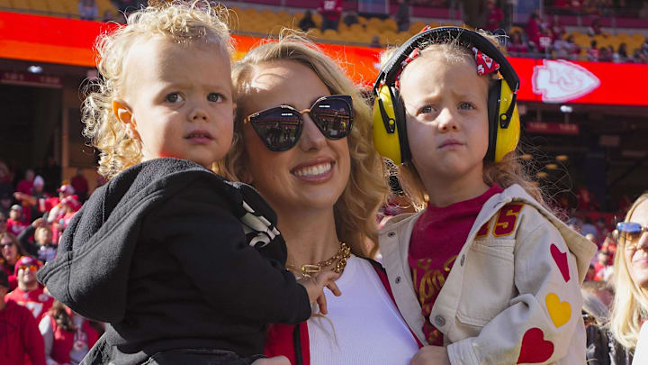 Brittany Mahomes and children watch warmups prior to game between the Kansas City Chiefs and the Denver Broncos at GEHA Field at Arrowhead Stadium.