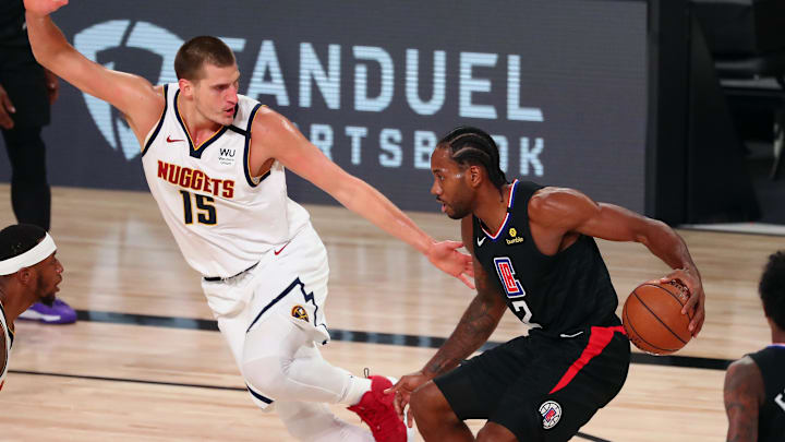 LA Clippers forward Kawhi Leonard (2) drives against Denver Nuggets center Nikola Jokic (15) during the first half of game two in the second round of the 2020 NBA Playoffs at AdventHealth Arena. Mandatory Credit: Kim Klement-Imagn Images