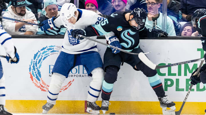 Feb 6, 2025; Seattle, Washington, USA;  Toronto Maple Leafs forward Pontus Holmberg (29) and  forward Andre Burakovsky (95) battle for the puck during the third period at Climate Pledge Arena. Mandatory Credit: Stephen Brashear-Imagn Images