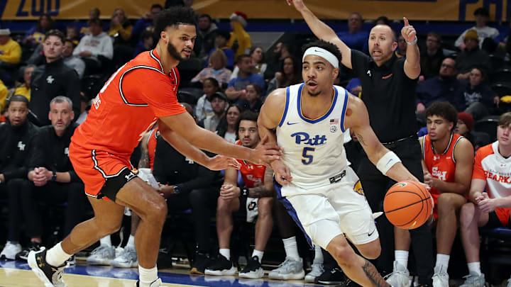 Dec 21, 2024; Pittsburgh, Pennsylvania, USA;  Pittsburgh Panthers guard Ishmael Leggett (5) dribbles the ball against Sam Houston State Bearkats forward Kian Scroggins (40) during the first half at the Petersen Events Center. Mandatory Credit: Charles LeClaire-Imagn Images