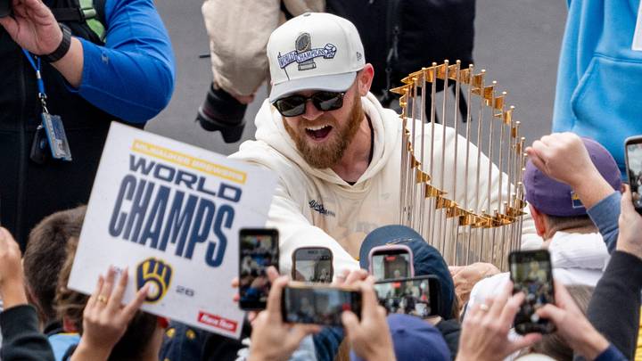 Milwaukee Brewers first baseman Jake Bauers (9) greets fans holding the Commissioner’s Trophy during the World Series parade on the intersection E Mason St and N Jackson St in Milwaukee, on Oct. 30, 2026.