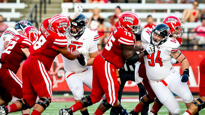 UL OL O'Cyrus Torrence and UL OL Kevin Dotson battle in the trenches in the football game between UL