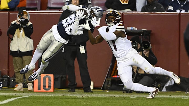 Dallas Cowboys cornerback DaRon Bland intercepts a pass intended for Commanders wide receiver Terry McLaurin.