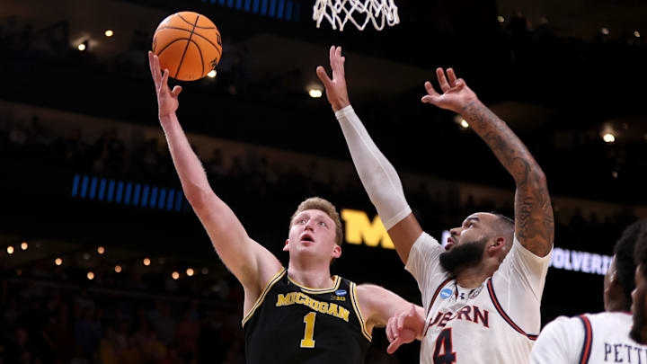 Mar 28, 2025; Atlanta, GA, USA; Michigan Wolverines center Danny Wolf (1) shoots against Auburn Tigers forward Johni Broome (4) in the second half of a South Regional semifinal of the 2025 NCAA tournament at State Farm Arena. Mar 28, 2025; Atlanta, GA, USA; Michigan Wolverines center Danny Wolf (1) shoots against Auburn Tigers forward Johni Broome (4) in the second half of a South Regional semifinal of the 2025 NCAA tournament at State Farm Arena.