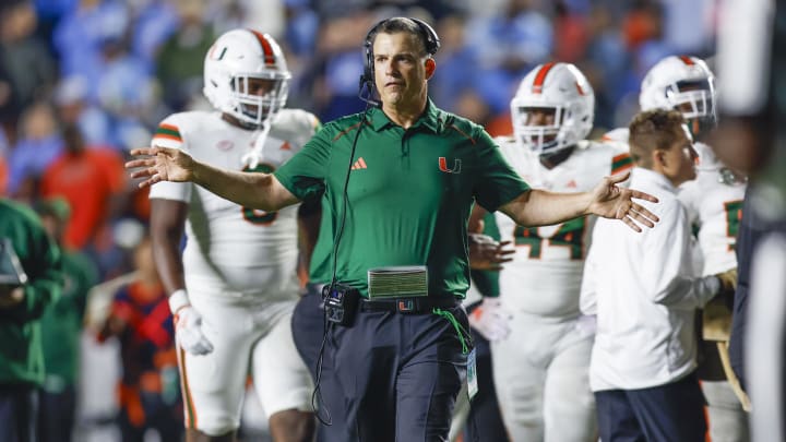 Oct 14, 2023; Chapel Hill, North Carolina, USA; Miami Hurricanes head coach Mario Cristobal stands on the field during a timeout as the Hurricanes play against the North Carolina Tar Heels in the second half at Kenan Memorial Stadium. Mandatory Credit: Nell Redmond-USA TODAY Sports