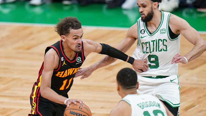 Apr 18, 2023; Boston, Massachusetts, USA; Atlanta Hawks guard Trae Young (11) drives the ball against Boston Celtics guard Malcolm Brogdon (13) and guard Derrick White (9) in the fourth quarter during game two of the 2023 NBA playoffs at TD Garden. Mandatory Credit: David Butler II-Imagn Images