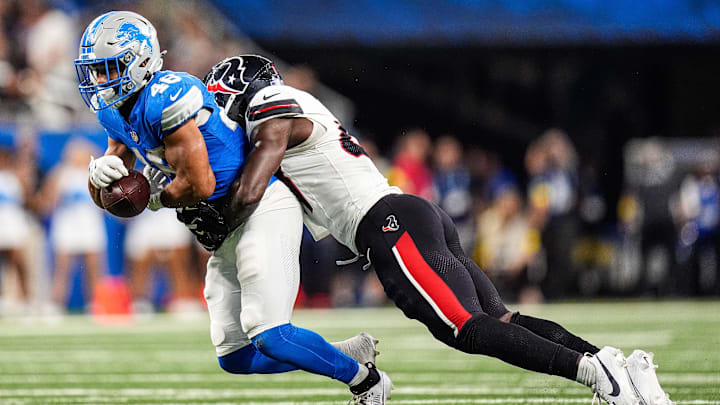 Detroit Lions running back Jacob Saylors (48) makes a catch against Houston Texans linebacker K.C. Ossai (47) during the second half at Ford Field in Detroit on Saturday, August 23, 2025. Detroit Lions running back Jacob Saylors (48) makes a catch against Houston Texans linebacker K.C. Ossai (47) during the second half at Ford Field in Detroit on Saturday, August 23, 2025.