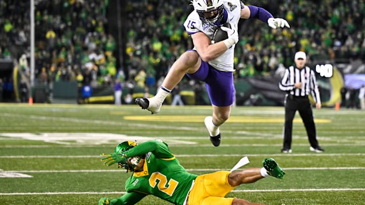 Dec 20, 2025; Eugene, OR, USA; James Madison Dukes tight end Lacota Dippre (15) hurdles over Oregon Ducks defensive back Kingston Lopa (2) to score a touchdown during the fourth quarter at Autzen Stadium. Mandatory Credit: Craig Strobeck-Imagn Images