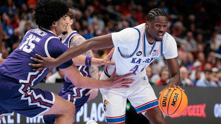 Mar 12, 2026; Kansas City, MO, USA; Kansas Jayhawks forward Flory Bidunga (40) drives to the basket around TCU Horned Frogs forward David Punch (15) during the first half at T-Mobile Center. Mandatory Credit: William Purnell-Imagn Images Mar 12, 2026; Kansas City, MO, USA; Kansas Jayhawks forward Flory Bidunga (40) drives to the basket around TCU Horned Frogs forward David Punch (15) during the first half at T-Mobile Center. Mandatory Credit: William Purnell-Imagn Images