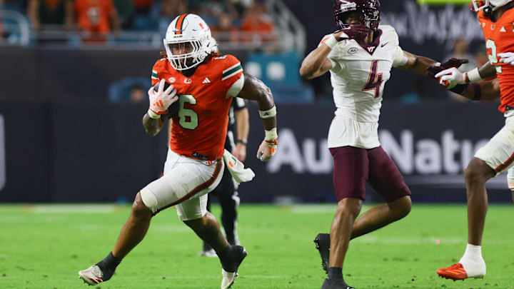 Sep 27, 2024; Miami Gardens, Florida, USA; Miami Hurricanes running back Damien Martinez (6) runs with the football against the Virginia Tech Hokies during the fourth quarter at Hard Rock Stadium. Mandatory Credit: Sam Navarro-Imagn Images