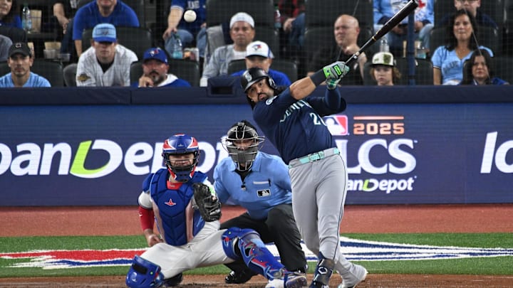 Oct 20, 2025; Toronto, Ontario, CAN; Seattle Mariners third baseman Eugenio Suarez (28) hits a single against the Toronto Blue Jays in the second inning during game seven of the ALCS round for the 2025 MLB playoffs at Rogers Centre. Mandatory Credit: Dan Hamilton-Imagn Images