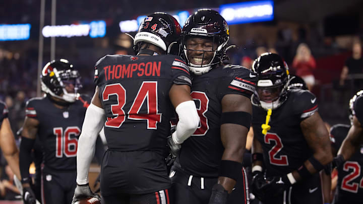 Oct 21, 2024; Glendale, Arizona, USA; Arizona Cardinals safety Jalen Thompson (34) celebrates with linebacker Jesse Luketa (43) after recovering a fumble from the Los Angeles Chargers in the first half at State Farm Stadium. Mandatory Credit: Mark J. Rebilas-Imagn Images