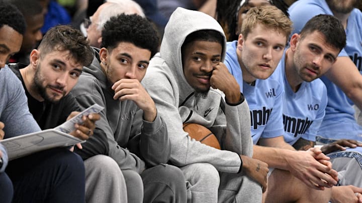Nov 22, 2025; Dallas, Texas, USA; Memphis Grizzlies guard Ja Morant (center) looks on from the team bench during the first quarter against the Dallas Mavericks at the American Airlines Center. Mandatory Credit: Jerome Miron-Imagn Images Nov 22, 2025; Dallas, Texas, USA; Memphis Grizzlies guard Ja Morant (center) looks on from the team bench during the first quarter against the Dallas Mavericks at the American Airlines Center. Mandatory Credit: Jerome Miron-Imagn Images