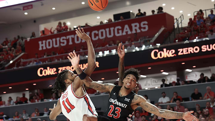 Mar 1, 2025; Houston, Texas, USA; Houston Cougars forward Joseph Tugler (11) collides with Cincinnati Bearcats forward Dillon Mitchell (23) in the first half at Fertitta Center. Mandatory Credit: Thomas Shea-Imagn Images Mar 1, 2025; Houston, Texas, USA; Houston Cougars forward Joseph Tugler (11) collides with Cincinnati Bearcats forward Dillon Mitchell (23) in the first half at Fertitta Center. Mandatory Credit: Thomas Shea-Imagn Images