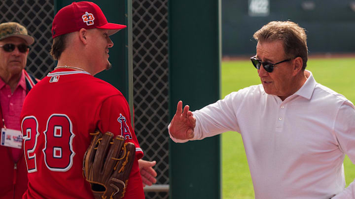 Feb 19, 2023; Tempe, AZ, USA; Los Angeles Angels team owner Arturo  Arte  Moreno (right) speaks with pitcher Aaron Loup (28) during spring training workout at Tempe Diablo Stadium. Mandatory Credit: Allan Henry-Imagn Images