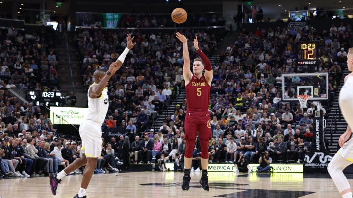 Apr 2, 2024; Salt Lake City, Utah, USA; Cleveland Cavaliers guard Sam Merrill (5) shoots a three point shot against Utah Jazz guard Kris Dunn (11) during the second quarter at Delta Center. Mandatory Credit: Rob Gray-USA TODAY Sports