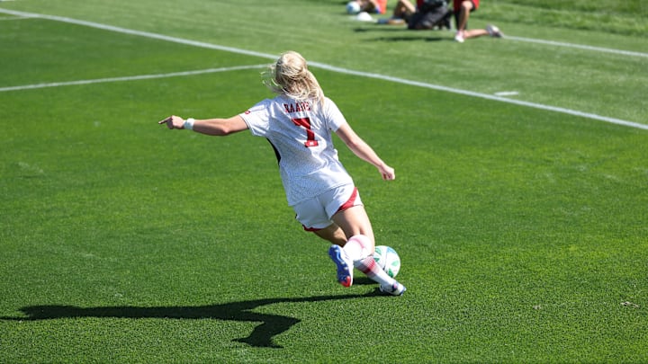 Nebraska midfielder Reagan Raabe plays a ball into the box against Iowa.