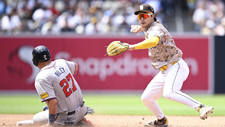 Jul 14, 2024; San Diego, California, USA; San Diego Padres shortstop Ha-Seong Kim (7) forces out Atlanta Braves third baseman Austin Riley (27) at second base during the sixth inning at Petco Park. Mandatory Credit: Orlando Ramirez-Imagn Images