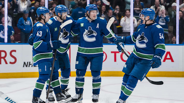 Apr 14, 2025; Vancouver, British Columbia, CAN; Vancouver Canucks forward Jake DeBrusk (74), forward Brock Boeser (6), defenseman Quinn Hughes (43) and forward Aatu Raty (54) celebrate DeBrusk’s goal against the San Jose Sharks in overtime at Rogers Arena. Mandatory Credit: Bob Frid-Imagn Images