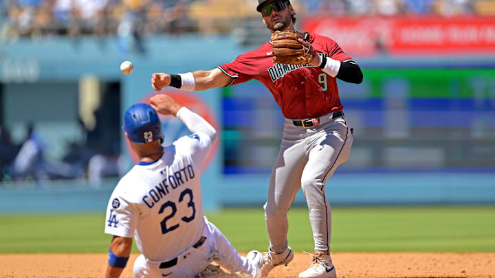 Aug 31, 2025; Los Angeles, California, USA;  Arizona Diamondbacks second baseman Blaze Alexander (9) throws to first as Los Angeles Dodgers left fielder Michael Conforto (23) is out at second base during the fourth inning at Dodger Stadium. Mandatory Credit: Jayne Kamin-Oncea-Imagn Images