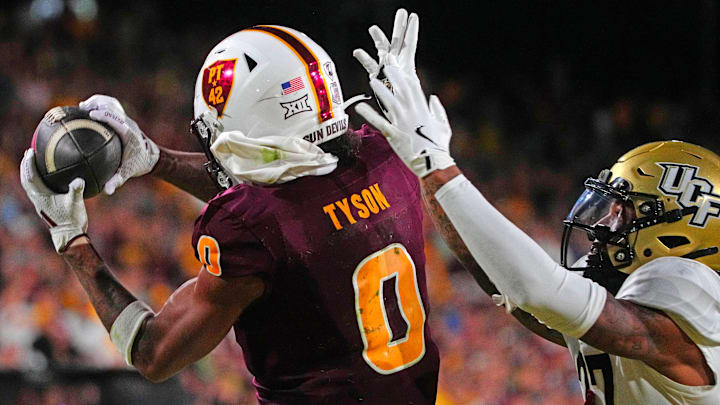 ASU wide receiver Jordyn Tyson (0) catches a touchdown pass against UCF defensive back Chasen Johnson (27) during a game at Mountain America Stadium in Tempe on Nov. 9, 2024.