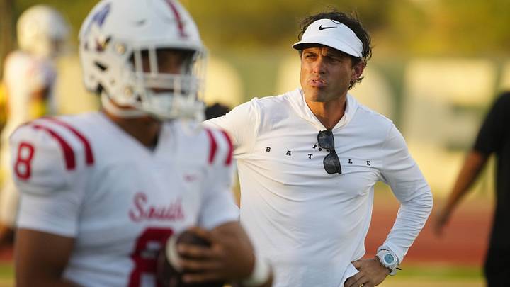 August 30, 2024; Chandler, Ariz.; USA; Millard South head coach Ty Wisdom watches his team warm up during a game against Basha at Basha High School. August 30, 2024; Chandler, Ariz.; USA; Millard South head coach Ty Wisdom watches his team warm up during a game against Basha at Basha High School.