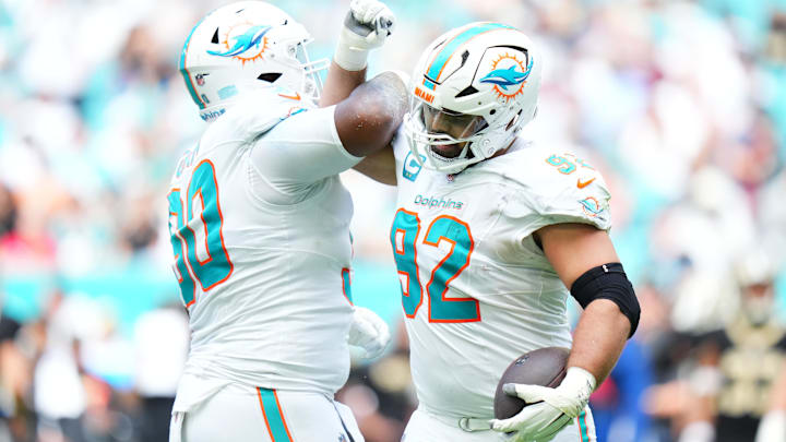 Miami Dolphins defensive tackle Zach Sieler (92) reacts with Miami Dolphins defensive tackle Kenneth Grant (90) after forcing a fumble against the New Orleans Saints during the first half at Hard Rock Stadium during the 2025 season.