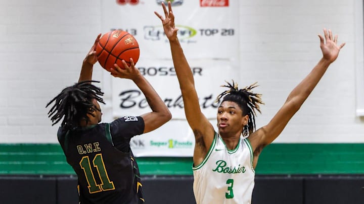 Bossier forward Kerel Woods (3) defending a 3-point shot by Calvary guard Tyrone Jamison (11) at the Bossier Basketball Invitational on Saturday, January 6, 2024, in Bossier City, La.