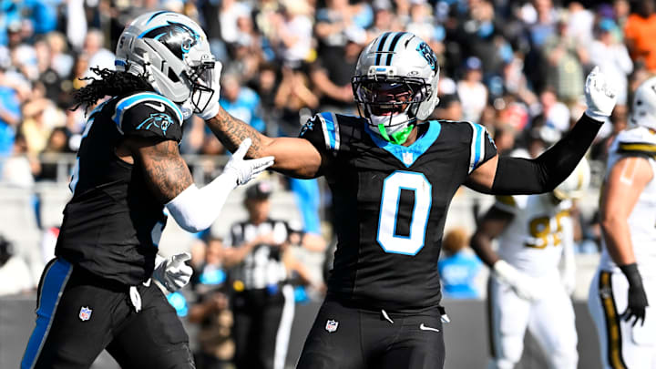 Nov 9, 2025; Charlotte, North Carolina, USA; Carolina Panthers running back Rico Dowdle (5) celebrates with tight end Ja'Tavion Sanders (0) after scoring a touchdown in the first quarter at Bank of America Stadium. 