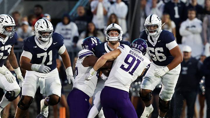 Penn State Nittany Lions quarterback Ethan Grunkemeyer (17) is tackled by Northwestern Wildcats defensive linesman Aidan Hubbard (91).