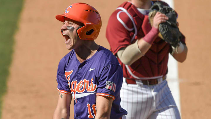 Clemson outfieler Cam Cannarella (10) celebrates after scoring under the tag of South Carolina sophomore Jake McCoy (23) during the top of the sixth inning of the Reedy River Rivalry at Fluor Field in Greenville, S.C. Saturday, March 1, 2025.