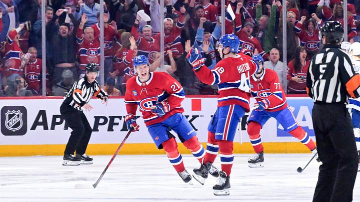 Apr 24, 2026; Montreal, Quebec, CAN; Montreal Canadiens defenseman Lane Hutson (48) celebrates with teammates including defenseman Kaiden Guhle (21) after scoring the winning goal against the Tampa Bay Lightning during the overtime period in game three of the first round of the 2026 Stanley Cup Playoffs at the Bell Centre. Mandatory Credit: Eric Bolte-Imagn Images