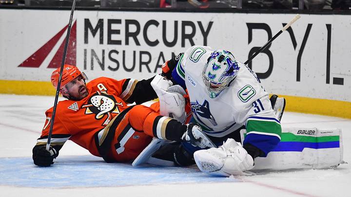 Oct 27, 2026; Anaheim, California, USA; Anaheim Ducks left wing Alex Killorn (17) collides with Vancouver Canucks goaltender Leevi Merilainen (31) during the overtime period at Honda Center. Killorn would be called for interference on the play.  Mandatory Credit: Gary A. Vasquez-Imagn Images