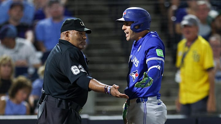 Sep 15, 2025; Tampa, Florida, USA; Toronto Blue Jays outfielder George Springer (21) talks to umpire Laz Diaz (63) during the eighth inning against the Tampa Bay Rays at George M. Steinbrenner Field. Mandatory Credit: Nathan Ray Seebeck-Imagn Images