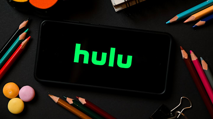 In this photo illustration a Hulu logo seen displayed on a...