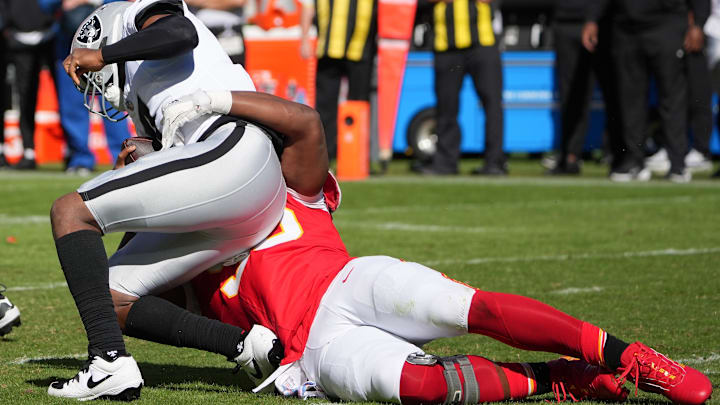 Oct 19, 2025; Kansas City, Missouri, USA; Kansas City Chiefs defensive end Chris Jones (95) sacks Las Vegas Raiders quarterback Geno Smith (7) during the third quarter of the game at GEHA Field at Arrowhead Stadium. Mandatory Credit: Denny Medley-Imagn Images