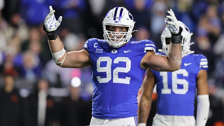 Oct 18, 2024; Provo, Utah, USA; Brigham Young Cougars defensive end Tyler Batty (92) encourages fans to cheer against the Oklahoma State Cowboys during the fourth quarter at LaVell Edwards Stadium. Mandatory Credit: Rob Gray-Imagn Images