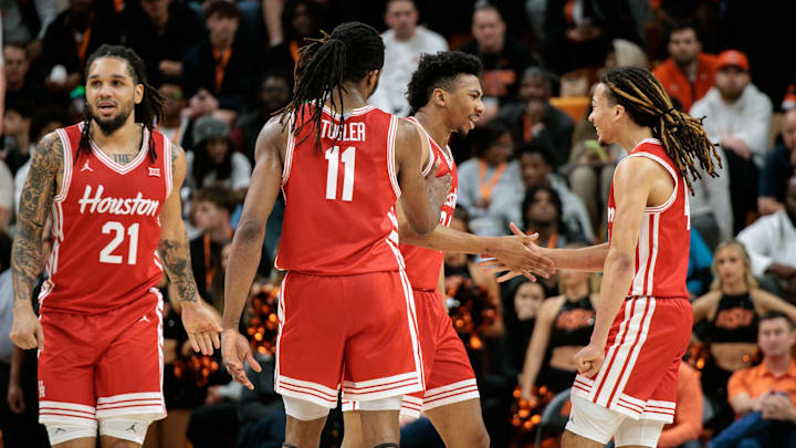 Mar 7, 2026; Stillwater, Oklahoma, USA; Houston Cougars guard Emanuel Sharp (21) and Houston Cougars guard Kingston Flemings (4) react after a play during the second half against the Oklahoma State Cowboys at Gallagher-Iba Arena. 