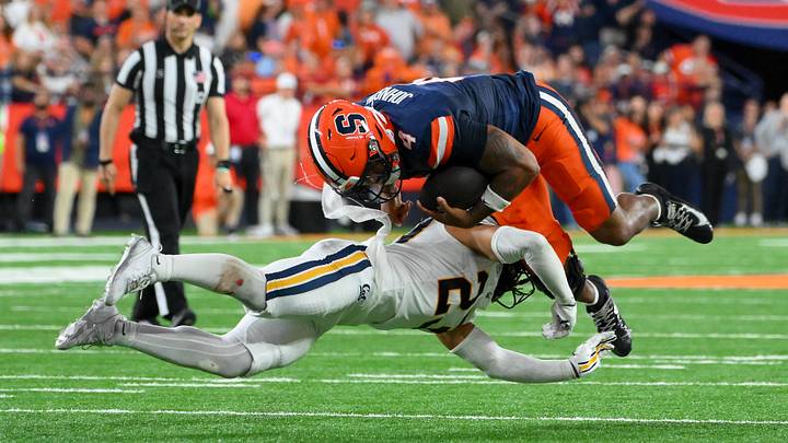 Cal defensive back Isaiah Crosby (23) tackles Syracuse running back Ju'juan Johnson.