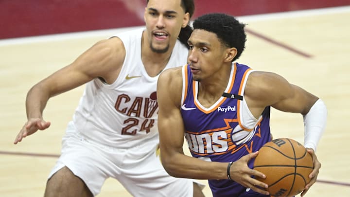 Jan 20, 2025; Cleveland, Ohio, USA; Phoenix Suns forward Ryan Dunn (0) drives beside Cleveland Cavaliers forward Jaylon Tyson (24) in the fourth quarter at Rocket Mortgage FieldHouse. Mandatory Credit: David Richard-Imagn Images