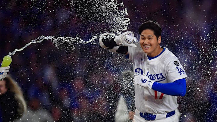 Los Angeles, California, USA; Los Angeles Dodgers designated hitter Shohei Ohtani (17) is greeted at home plate after hitting a walk off solo home run against the Atlanta Braves during the ninth inning at Dodger Stadium.