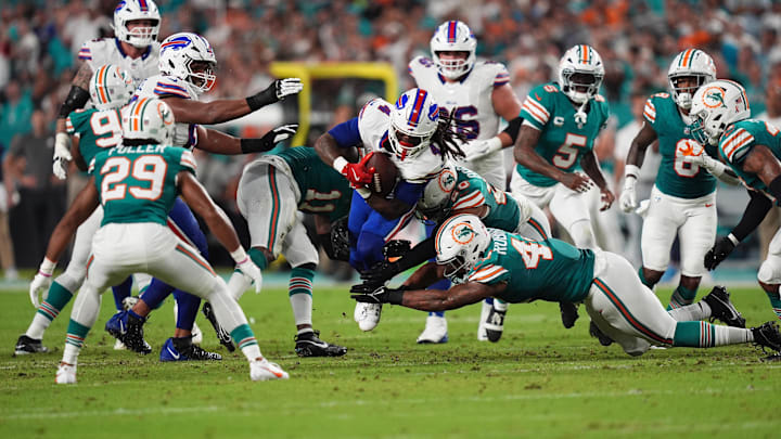 Miami Dolphins linebacker Chop Robinson (44), linebacker David Long Jr. (11) and linebacker Jordyn Brooks (20) attempt to bring down Buffalo Bills running back James Cook (4) during the first half at Hard Rock Stadium in Week 2.