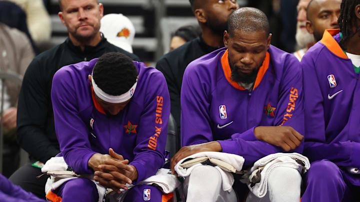 Dec 19, 2024; Phoenix, Arizona, USA; Phoenix Suns guard Bradley Beal (left) and forward Kevin Durant react on the bench against the Indiana Pacers at Footprint Center. Mandatory Credit: Mark J. Rebilas-Imagn Images