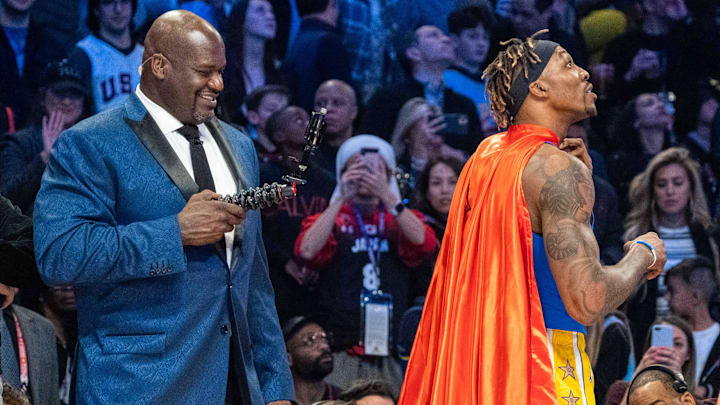 February 15, 2020; Chicago, Illinois, USA: NBA great Shaquille O'Neal (left) videotapes Los Angeles Lakers player Dwight Howard (right) in a Superman costume dedicated to the late Los Angeles Lakers great Kobe Bryant during NBA All Star Saturday Night at United Center. Mandatory Credit: Kyle Terada-Imagn Images