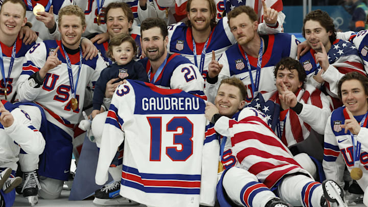Feb 22, 2026; Milan, Italy; United States players celebrate with a team photo while holding the jersey of Johnny Gaudreau after defeating Canada in the men's ice hockey gold medal game during the Milano Cortina 2026 Olympic Winter Games at Milano Santagiulia Ice Hockey Arena. Mandatory Credit: Geoff Burke-Imagn Images Feb 22, 2026; Milan, Italy; United States players celebrate with a team photo while holding the jersey of Johnny Gaudreau after defeating Canada in the men's ice hockey gold medal game during the Milano Cortina 2026 Olympic Winter Games at Milano Santagiulia Ice Hockey Arena. Mandatory Credit: Geoff Burke-Imagn Images